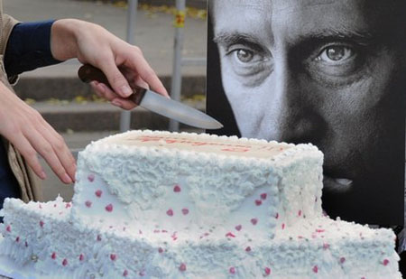 An activist of 'Army of Putin' cuts a birthday cake in honor of Vladimir Putin, Moscow, October 7, 2011.