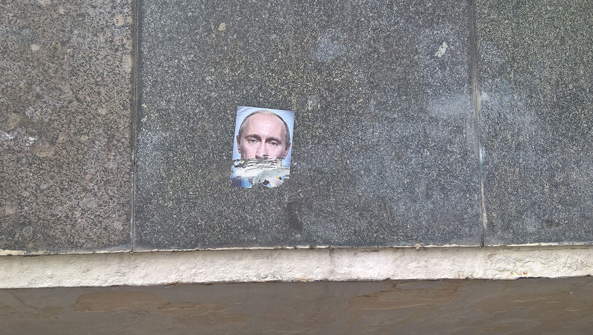 iscepana nalepnica sa likom Putina na zidu