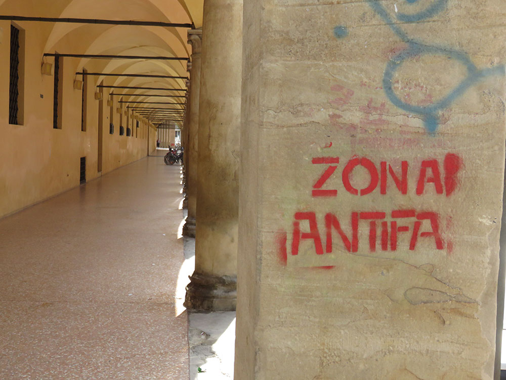 Natpis Zona antifa na stubu u Bolonji