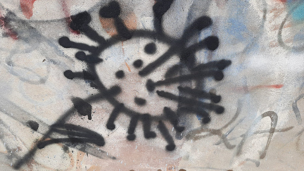 crtež sprejem na zidu koji podseća na korona virus