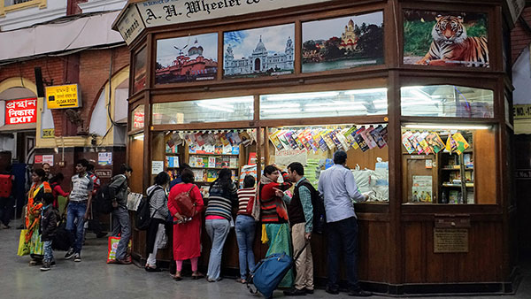 ljudi ispred štanda za novine u Indiji